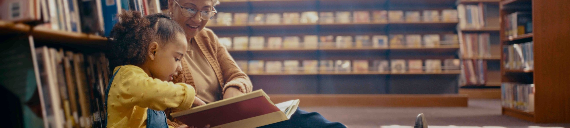 Senior reading to child